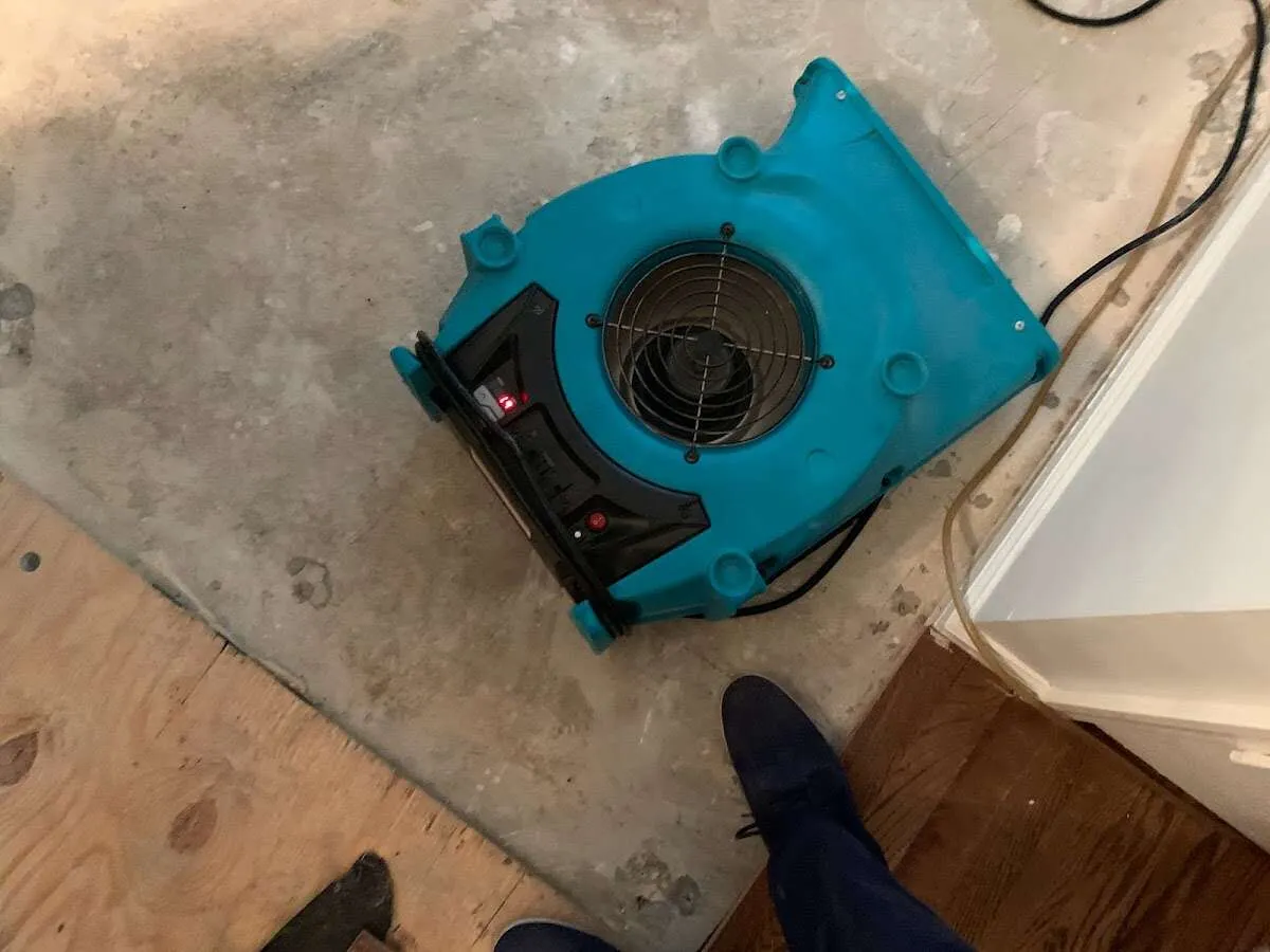 Air mover drying subfloor during Commercial Water Damage Restoration in Highland City